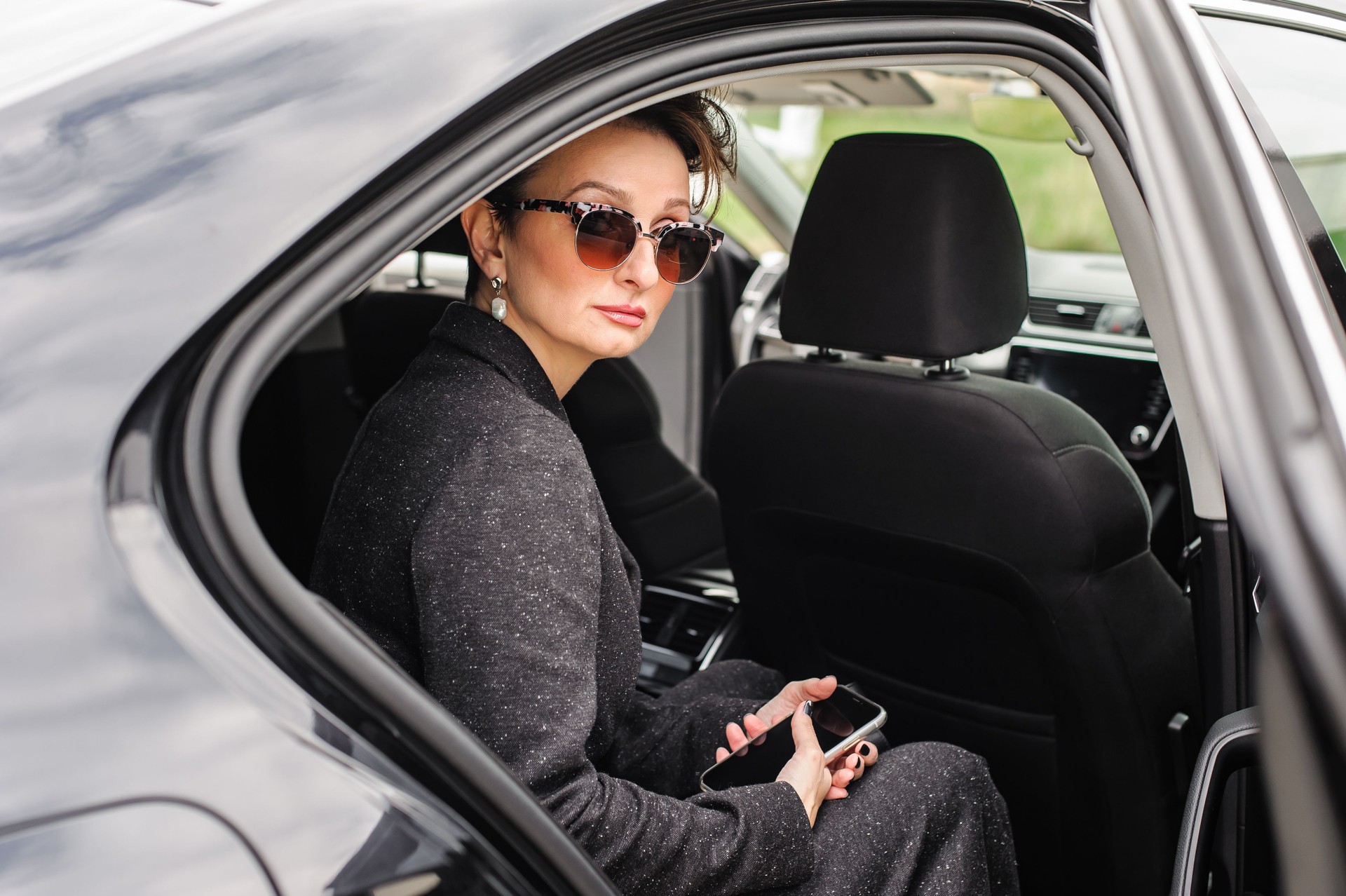 Business woman VIP celebrity public person in luxury car limousine